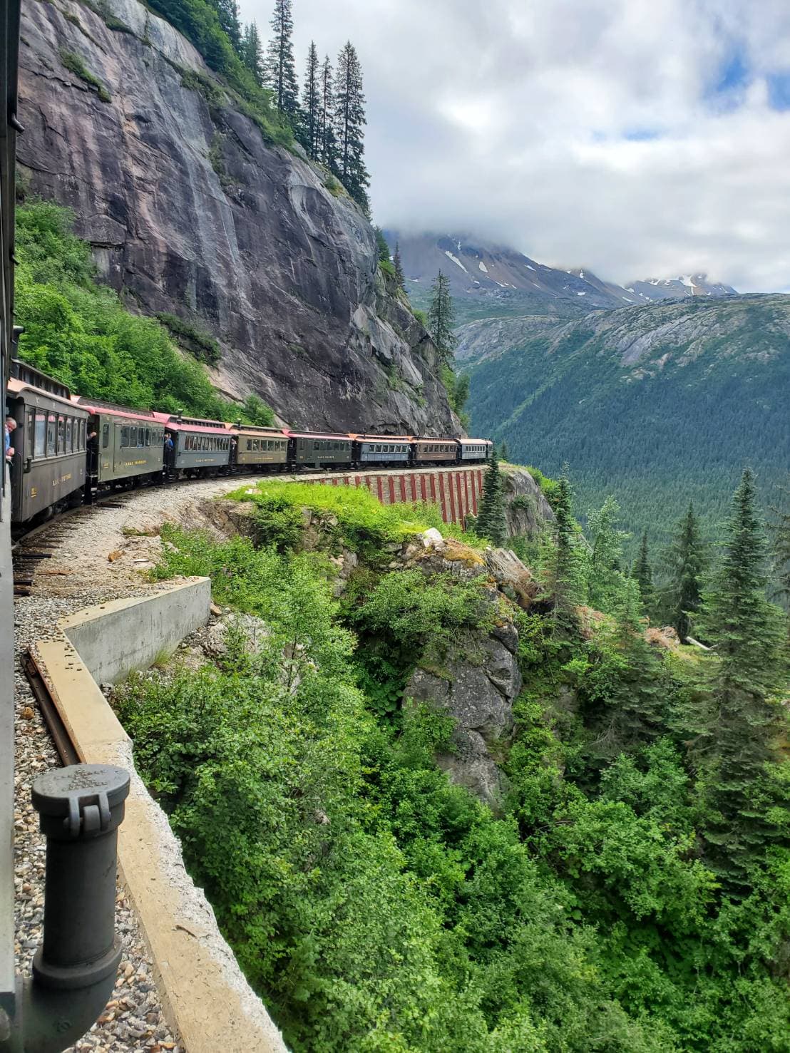 White Pass train curving along a mountain cliff near Skagway